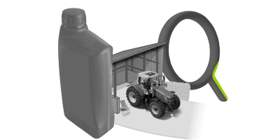 Ein Traktor steht vor einer Halle. Im Hintergrund ist eine Lupe und im Vordergrund eine &Ouml;ldose.
